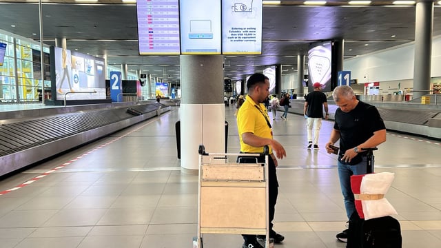 Miniatura: Pasajero usando servicio de auto-servicio de carro de equipaje en El Dorado